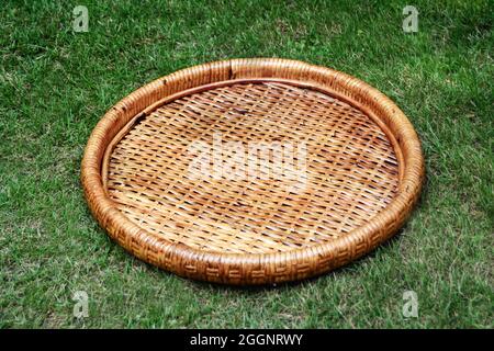 round cane tray with green background selective focus Stock Photo