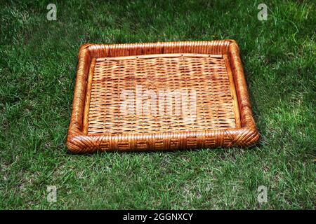 Rattan cane tray dark brown color with outdoor background selective soft focus Stock Photo