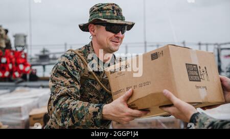 U.S. Marine Corps 1st Sgt. Vitali Kholodov, a native of Bend, Ore., with 1st Battalion, 6th Marine Regiment, 2d Marine Division, helps offload boxes for redistribution in Port of Jeremie, Haiti, Aug. 31, 2021.   “I have been in the Marine Corps for 17 years, but have never had the opportunity to support humanitarian relief efforts.  It was an incredible experience,” Kholodov said. 1st Battalion, 6th Marine Regiment is serving as the Marine entity under Joint Task Force- Haiti for the humanitarian relief efforts following the earthquake in Haiti. “I am here for the Marines. To see them come tog