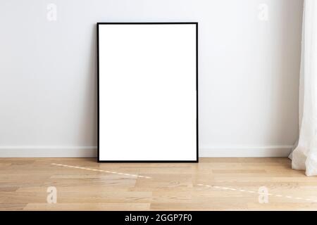 Rectangular mock up standing in a room with wooden flooring. Stock Photo