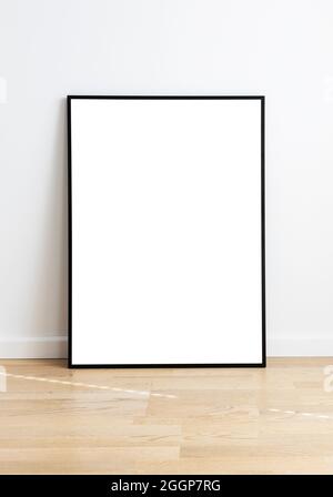 Rectangular mock up standing in a room with wooden flooring and white wall- Stock Photo