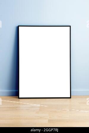 Rectangular mock up standing in a room with wooden flooring and blue wall. Stock Photo