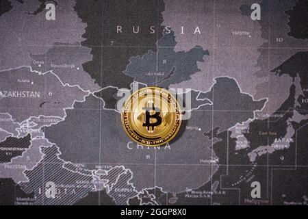 one gold bitcoin is lay on the world map over the name of country. Cryptocurrency bitcoin the future coin is the important currency for pay everything Stock Photo