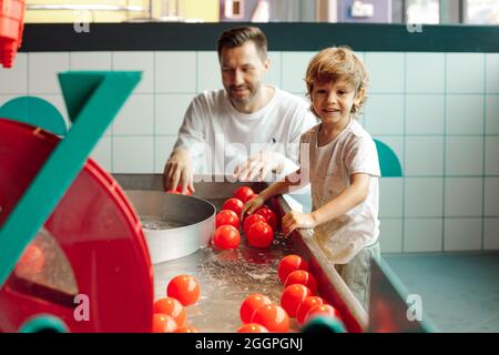 Single father plays with his son in entertainment children's center with balls floating on water. Learning through game. Childhood. Educational games. Stock Photo