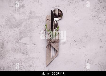 Cutlery set. Stylish white cutlery at  napkin. Top view on kitchen table. Stock Photo