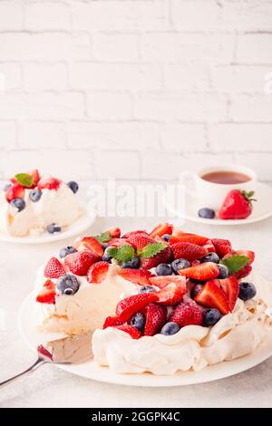 Delicious Pavlova cake with fresh strawberry and blueberry, selective focus Stock Photo