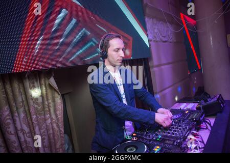 Odessa, Ukraine April 26, 2014: Dj at work in luxury nightclub during night party. Dj make party time at elite night club. Stock Photo