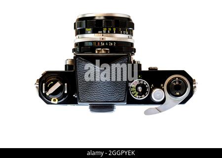 Horizontal shot of a professional 1960’s 35mm SLR camera from above isolated on white. Stock Photo
