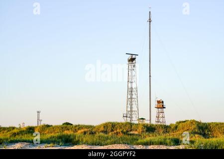 Baltic Sea coast surveillance, navigation and communication towers with equipment Stock Photo