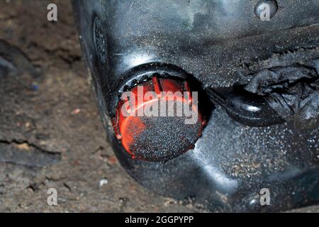 Black dirty plastic oil can. Old oiled canister with red cap Stock Photo