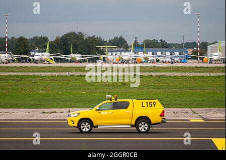 Riga, Latvia - August 31, 2021: yellow airport aviation bird control car at Riga International Airport (RIX) Stock Photo