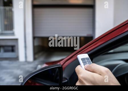 Automatic Wireless Home Garage Door. Hand Using Controller In Car Stock Photo