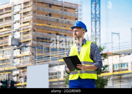 OSHA Inspector At Construction Site. Young Engineer Worker Stock Photo