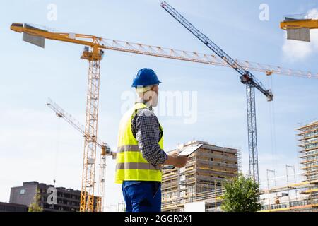 OSHA Inspector At Construction Site. Young Engineer Worker Stock Photo