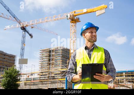OSHA Inspector At Construction Site. Young Engineer Worker Stock Photo