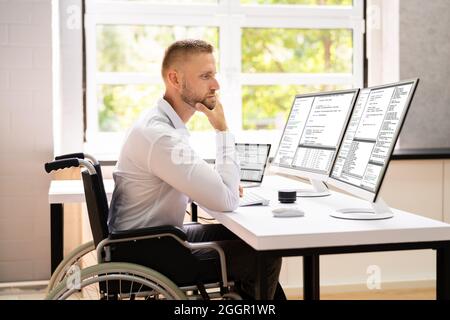 Computer Programmer Writing Program Code On Computer In Office Stock Photo