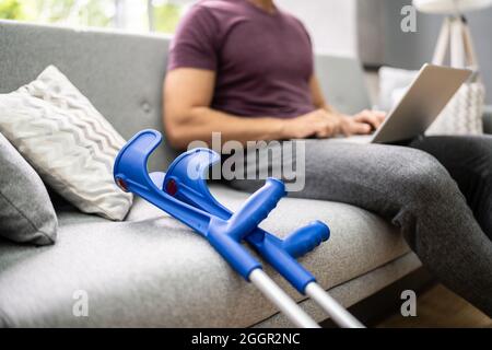 Leg Injured Man With Crutches After Accident Stock Photo