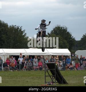 The Stannage Stunt Team Showing the crowd how to leap over a white van at The Cheshire Game and Country Fair Stock Photo