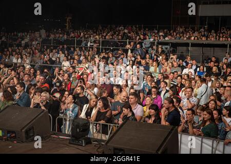 Odessa, Ukraine July 11, 2019: Many spectators at concert. crowd of visitors to concert has fun and shoots what is happening on smartphones. Fans at c Stock Photo