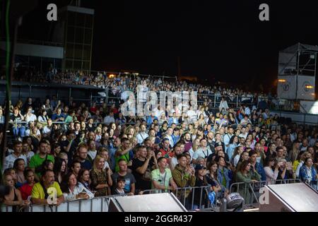 Odessa, Ukraine July 11, 2019: Many spectators at concert. crowd of visitors to concert has fun and shoots what is happening on smartphones. Fans at c Stock Photo