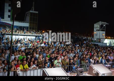 Odessa, Ukraine July 11, 2019: Many spectators at concert. crowd of visitors to concert has fun and shoots what is happening on smartphones. Fans at c Stock Photo