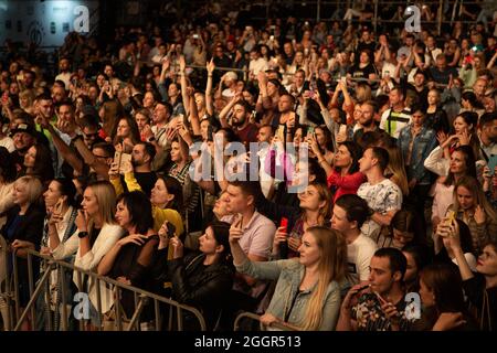 Odessa, Ukraine July 11, 2019: Many spectators at concert. crowd of visitors to concert has fun and shoots what is happening on smartphones. Fans at c Stock Photo