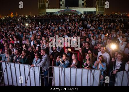 Odessa, Ukraine July 11, 2019: Many spectators at concert. crowd of visitors to concert has fun and shoots what is happening on smartphones. Fans at c Stock Photo