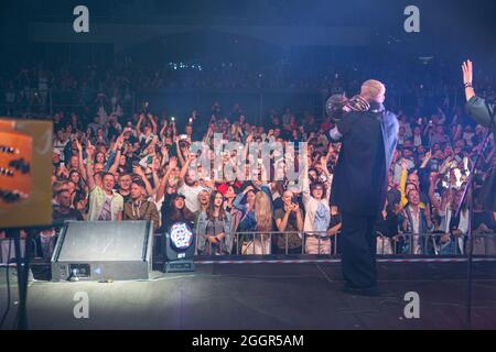 Odessa, Ukraine July 11, 2019: Many spectators at concert. crowd of visitors to concert has fun and shoots what is happening on smartphones. Fans at c Stock Photo