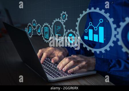 Data science analyst working with statistics and report on computer. Concept with icons of charts and graph connected. Business analytics consultant a Stock Photo