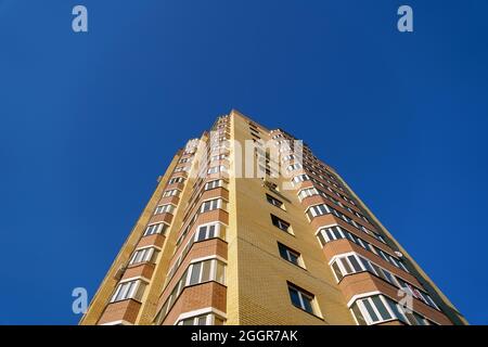 Tyumen, Russia-August 31, 2021: Architecture. Construction of a new multi-storey brick house with windows, bottom view Stock Photo