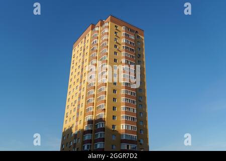 Tyumen, Russia-August 31, 2021: Multi-storey brick residential building of 20 floors. Bottom view Stock Photo