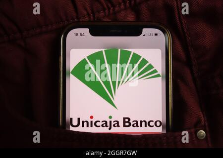 KONSKIE, POLAND - August 17, 2021: Unicaja Banco logo displayed on mobile phone hidden in jeans pocket Stock Photo