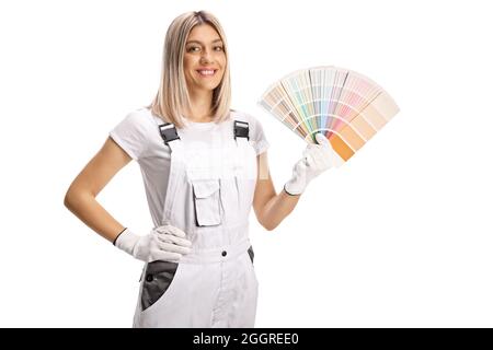 Female house painter in a white uniform holding a color palette and smiling isolated on white background Stock Photo