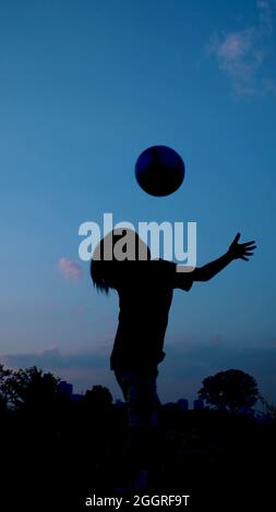 Shadow of a children who is playing with a ball Stock Photo