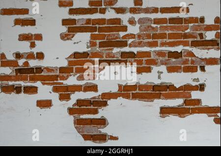 Old red brick wall partially plastered and white painted, background texture for historical architecture concepts, copy space, selected focus Stock Photo