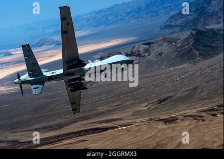 A U.S. Air Force General Atomics MQ-9 Reaper unmanned aerial vehicle flies a training mission over the Nevada Testing and Training area at Creech Air Force Base June 29, 2015 in Indian Springs, Nevada. Stock Photo