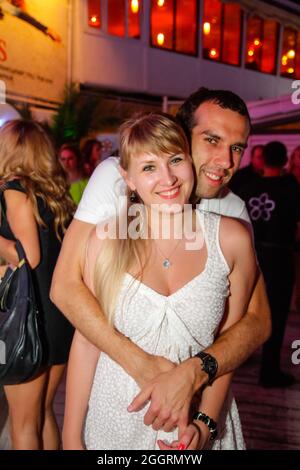 Odessa, Ukraine June 28, 2013: Ibiza night club. People smiling and posing on cam during concert in night club party. Man and woman have fun at club. Stock Photo