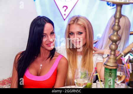 Odessa, Ukraine June 28, 2013: Ibiza night club. People smiling and posing on cam during concert in night club party. Man and woman have fun at club. Stock Photo