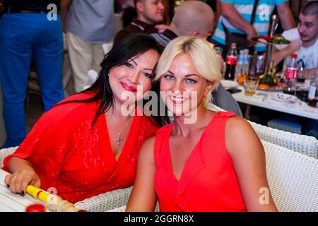 Odessa, Ukraine June 28, 2013: Ibiza night club. People smiling and posing on cam during concert in night club party. Man and woman have fun at club. Stock Photo