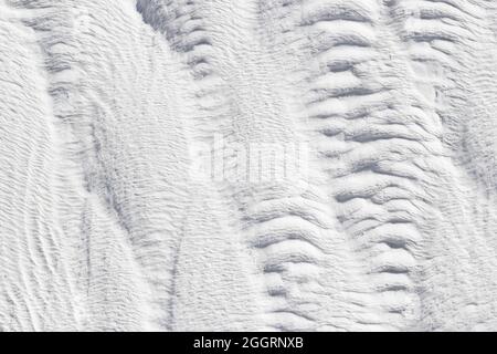 Abstract gray and white texture of Pamukkale calcium travertine in Turkey, vertical pattern, close-up. Stock Photo