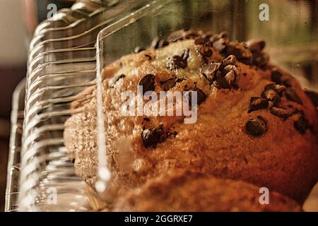 Store bought chocolate chip muffin in clear packaging close up Stock Photo
