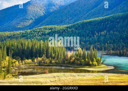 Moon Bay of Kanas Lake. The curved river with crystal blue water. Green trees. The natural beauty of the paradise. Kanas Nature Reserve. Xinjiang Prov Stock Photo