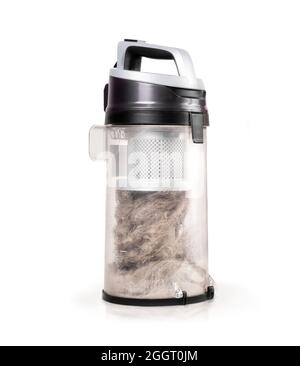 Cyclonic vacuum canister filled to the top with dust, debris, pet fur and hair. Large overfilled vac container after cleaning the home or apartment. S Stock Photo