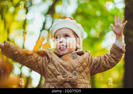 A little girl holding her hands up Stock Photo