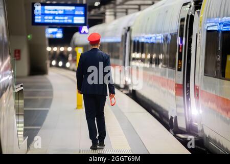 Berlin, Germany. 03rd Sep, 2021. A platform supervisor walks next to an ICE train at Berlin Central Station. Credit: Christoph Soeder/dpa/Alamy Live News Stock Photo