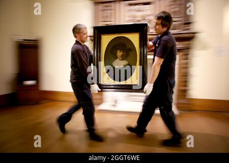 File photo dated 06/04/17 art technicians Andy Cavanagh (left) and Paul McCall moving a painting entitled 'Self Portrait' (1632) by Rembrandt at the Burrell Collection, Glasgow prior to the museum renovation. An art collection amassed by a shipping magnate is to go back on show to the public in March next year after a £68.25 million museum renovation. Issue date: Friday September 3, 2021.