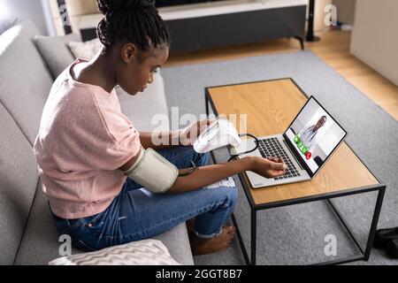 African American Patient Testing Blood Pressure In Telehealth Telemedicine Call Stock Photo