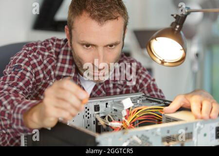 computer repairman on wheelchair working Stock Photo