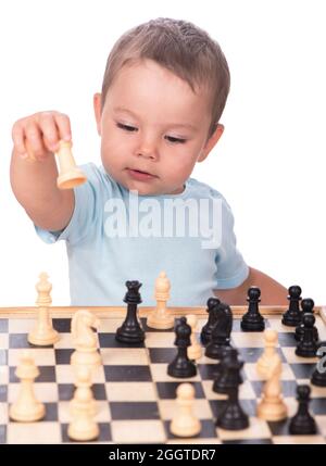 little boy staring at the chess pieces isolated on white background Stock Photo