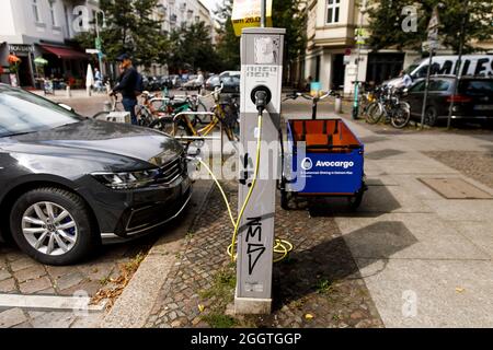 Berlin, Germany. 02nd Sep, 2021. An electric car stands at a charging station in a residential area in the Prenzlauer Berg district. An Avocargo e-bike (r) stands in front of it. Credit: Carsten Koall/dpa/Alamy Live News Stock Photo